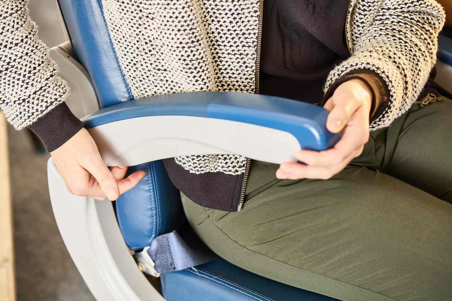 This Secret Button on Your Airplane Seat Gives You More Space