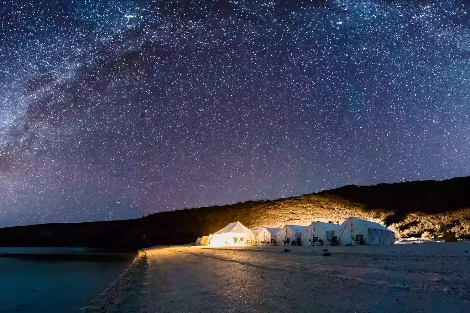 This Pristine Uninhabited Island Has an Oceanfront All-inclusive Glamping Site — and Its Sea Is Known as the 'Aquarium of the World’